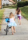 Girls running and riding a bike Royalty Free Stock Photo