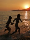 Girls running at sea Royalty Free Stock Photo