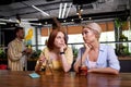 Girls are sad in bar while others are having fun Royalty Free Stock Photo