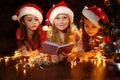 Girls in Santa hats have a Christmas Royalty Free Stock Photo