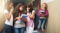 Girls, school and bullying student in gossip, secret or whisper down the corridor or hallway. Group of young kids or Royalty Free Stock Photo