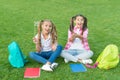 Girls school pupils doing homework together on fresh air, develop creativity concept