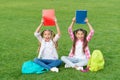 Girls school pupils doing homework together on fresh air, knowledge day concept