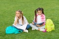 Girls school pupils doing homework together on fresh air, sad and tired concept