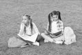Girls school pupils doing homework together on fresh air, sad and tired concept