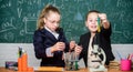 Girls school uniform busy with proving their hypothesis. Private school. School project investigation. School experiment