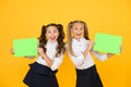 Girls school uniform hold poster. School girls show poster. Social poster copy space. Socialization involves how