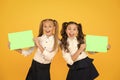 Girls school uniform hold poster. School girls show poster. Social poster copy space. Socialization involves how