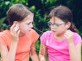 Girls sharing headphones to listen to music