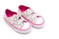 Girls` shoes in flowers and pink color on a white background. Fl