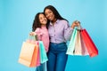 African American woman and girl posing with shopping bags Royalty Free Stock Photo