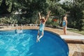 Girls sisters diving in water on home backyard pool. Children siblings friends enjoying and having fun in swimming pool together. Royalty Free Stock Photo