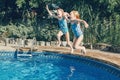 Girls sisters diving in water on home backyard pool. Children siblings friends enjoying and having fun in swimming pool together. Royalty Free Stock Photo