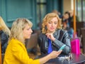 Girls sit in a cafe and shop Royalty Free Stock Photo