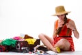 Girls sits near overfilled suitcase. Royalty Free Stock Photo