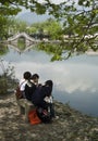 Girls sitting on a bench in Hongcun (China).