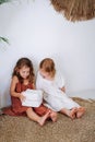 Girls sitting on the floor play enthusiastically