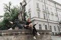 Girls sitting at the fountain. Summer holidays concept Royalty Free Stock Photo