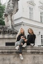 Girls sitting at the fountain. Summer holidays concept Royalty Free Stock Photo