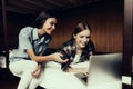 Girls sitting and lie on bed and looking at laptop Royalty Free Stock Photo