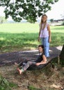 Girls sitting and standing on tire Royalty Free Stock Photo