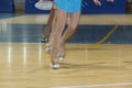 Girls skating with roller skates during an artistic figure skating competition. view of the legs