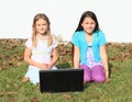 Girls smiling behind a notebook Royalty Free Stock Photo