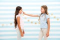 Girls smiling happy faces play or interact stand striped background. Girl best friend involved communication game touch