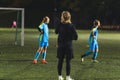 girls with soccer blue uniforms having evening class in a stadium, full shot, sports concept