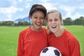 Girls, soccer players and portrait with ball, happiness and football field for match, competition or game. Fitness Royalty Free Stock Photo