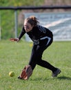 Girls softball - fielding in the outfield Royalty Free Stock Photo