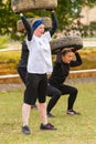 Girls squat with the tire.