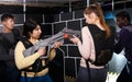 girls standing face to face with laser guns on lasertag gaming arena Royalty Free Stock Photo