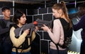 girls standing face to face with laser guns on lasertag gaming arena