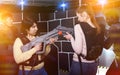girls standing face to face with laser guns on lasertag gaming a Royalty Free Stock Photo