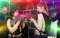 Girls standing face to face with laser guns on lasertag gaming a Royalty Free Stock Photo