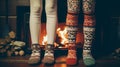 Girls standing in front of fireplace in winter sweaters wearing. Feet in wool socks near fireplace Royalty Free Stock Photo