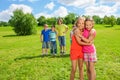 Girls standing in the park hugging