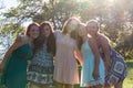 Girls Standing Together With Trees in the Background