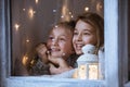 Girls standing beside window