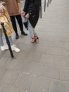 Girls in stilettos and sneakers. Street fashion