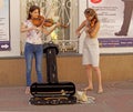 Girls street musicians playing violins