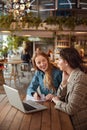 Girls. Students Studying With Laptop. Beautiful Young Women Having Discussion. Smiling Blonde And Brunette Looking At Each Other Royalty Free Stock Photo