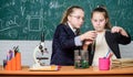 Girls study chemistry. Make studying chemistry interesting. Educational experiment concept. Microscope and test tubes on