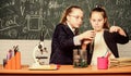 Girls study chemistry. Make studying chemistry interesting. Educational experiment concept. Microscope and test tubes on