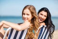 Girls sunbathing on the beach chairs