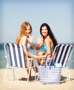 Girls sunbathing on the beach chairs Royalty Free Stock Photo