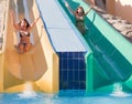 Girls in swimming pool water slide Royalty Free Stock Photo