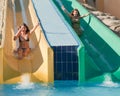 Girls in swimming pool water slide Royalty Free Stock Photo