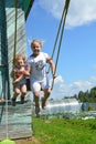 Girls swing on a swing in Sunny warm weather. Royalty Free Stock Photo